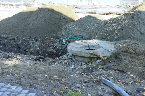 istock Breaking asphalt on a road in order to collect wastewater during earthworks construction 1815241294