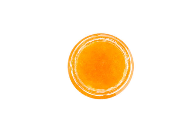 istock glass bowl with orange jam isolated on white background. 1815245544