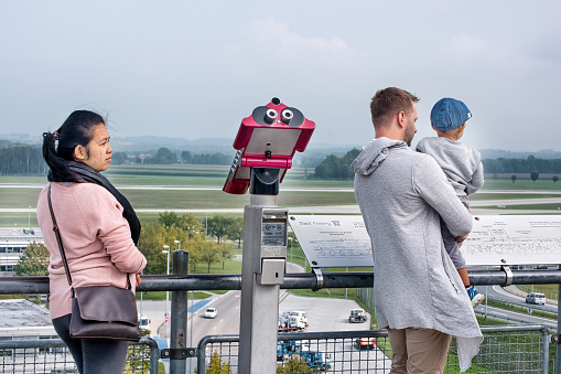 Visitors watching through telescopes planes taking-off at Munich airport: Munich, Germany - September 15, 2018