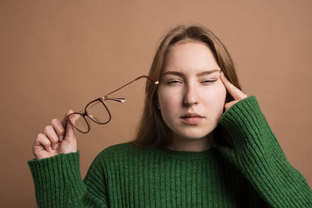 istock woman with poor vision on a isolated beige background, health problems astigmatism myopia, Poor vision concept 1815253933