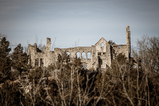 Overlooking the rugged landscapes of Ha Ha Tonka State Park in Missouri, these remains of a once-stately mansion evoke a sense of historic grandeur and mystery. The skeletal structure stands as a silent testament to the past, with bare trees softly framing the ancient stones.