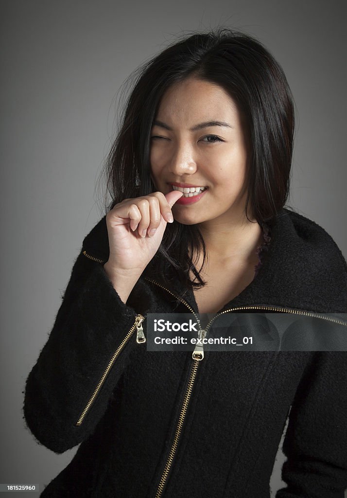 20 s Attractive Asian girl wearing un hoodie sobre fondo gris - Foto de stock de 20 a 29 años libre de derechos