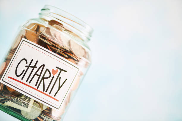 istock Charitable donation jar filled with American currency. Shot with space for text 1815260711