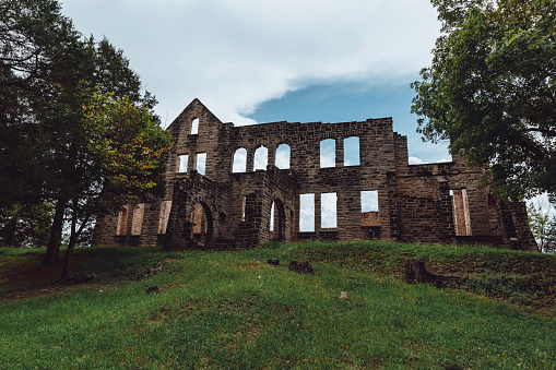 Explore the hauntingly beautiful remains of Ha Ha Tonka Castle, a testament to a bygone era. Perched high above the mesmerizing Lake of the Ozarks, these crumbling stone walls and archways tell a tale of opulence turned to ruins. Nature and history intertwine in this evocative photograph, offering a glimpse into the past.