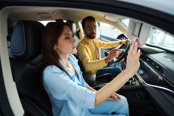 istock Young couple choosing auto in car showroom 1815271339