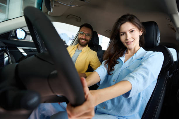 istock Happy couple posing at camera in car interior 1815271531