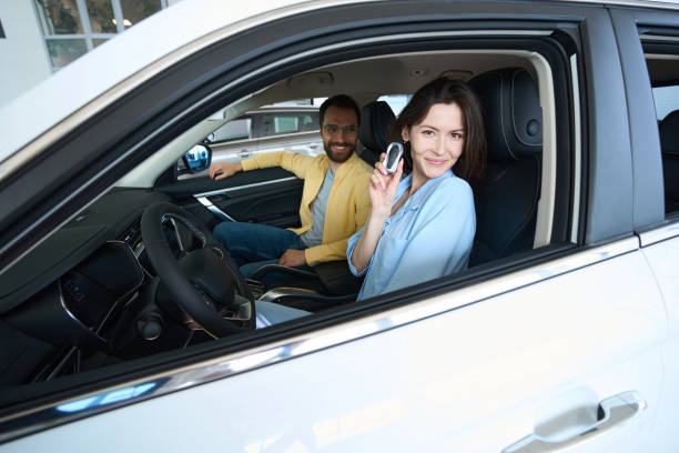 istock Pretty female posing at camera in car interior 1815271876