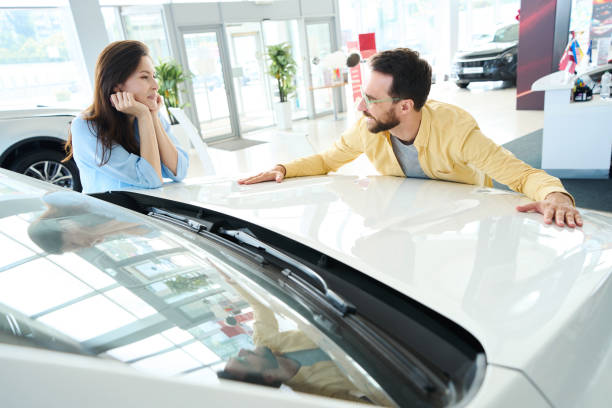 istock Loving couple choosing auto in car center 1815271894