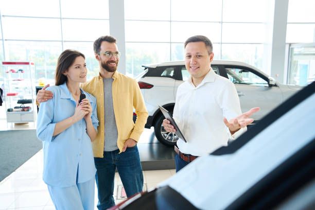 istock Happy couple choosing auto in car center 1815271914