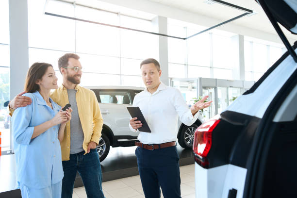 istock Loving couple choosing auto in car center 1815271920