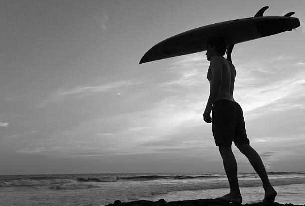 istock Man surfer with surfboard on a coastline. Bali. Indonesia 181536132