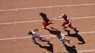 istock Male relay runners passing batons on track 181538149