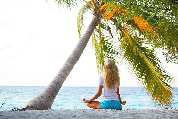 istock yoga woman under palm 181538870