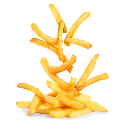 Tasty French fries falling into pile on white background