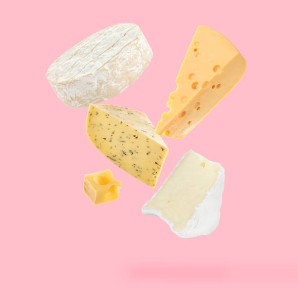 istock Different kinds of cheese falling on pink background 1815389828