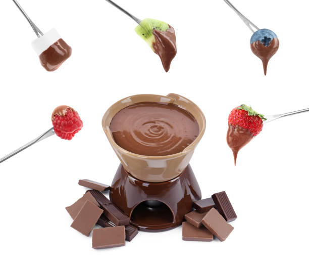 istock Fondue pot, forks with fruits and marshmallow dipped into chocolate isolated on white, set 1815389830