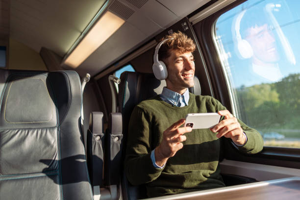 istock Enjoying the view on a train drive. A young man is traveling by train. 1815394045