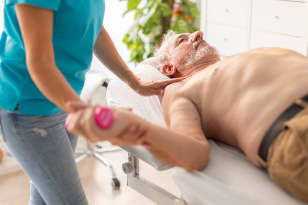 istock An older, retired man receives a physiotherapy and rehabilitation session, using light weights, to treat a problem in his wrist and arm joint 1815423152