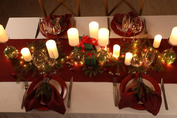 istock Christmas table setting with burning candles and festive decor, above view 1815423703