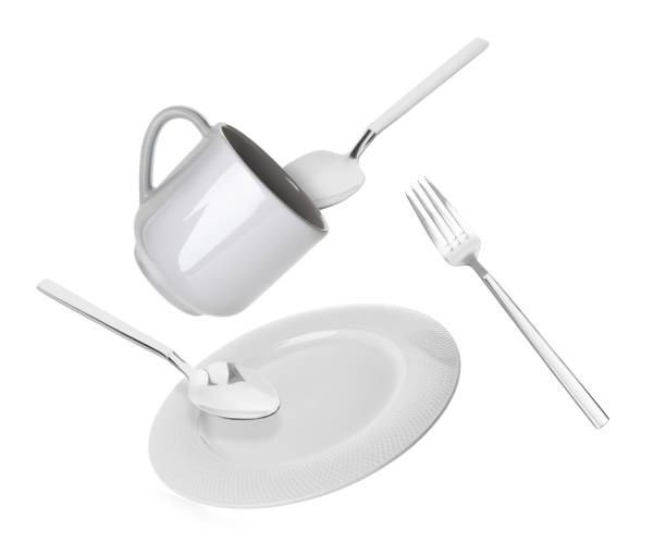 istock Clean plate, cup and cutlery falling on white background 1815425913