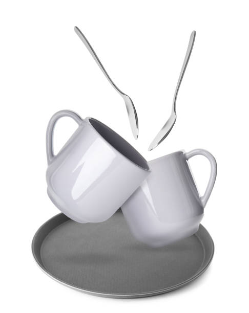 istock Clean plate, spoons and cups falling on white background 1815425916