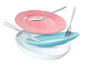 Clean plates, spoon, knife and fork falling on white background
