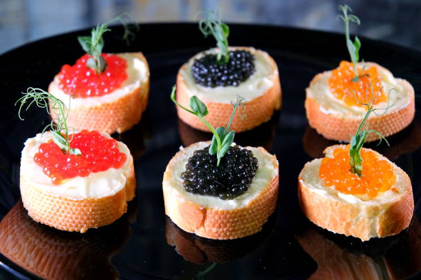 istock Partitioned dish with black and red caviar on wooden background 1815432859