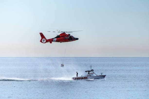 A Coast Guard gunman (face is obscured) stands beside his high power machine gun.  Aerial View.More marine and Chesapeake Bay images: