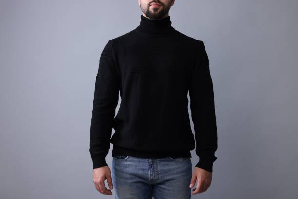 istock Man in stylish black sweater on grey background, closeup 1815471679