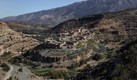A Moroccan abandoned village on a rock formation carved out by the river below