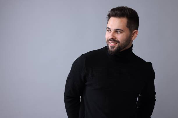istock Happy man in stylish black sweater on grey background, space for text 1815475431