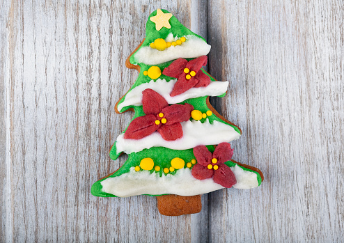Festive Christmas Cookie and New Year in the shape of a Christmas tree on white rustic table