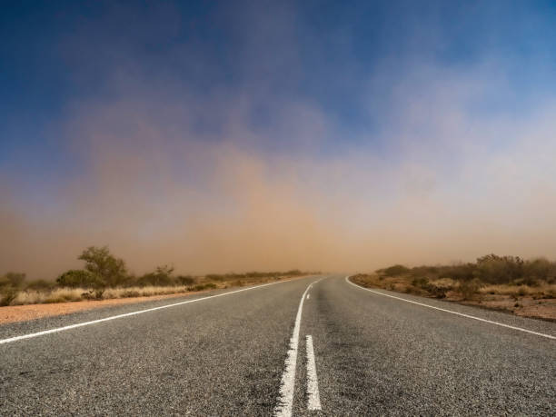 Dust storm on road Dust storm on the remote roads in the Pilbara Western Australia scribbly gum stock pictures, royalty-free photos & images