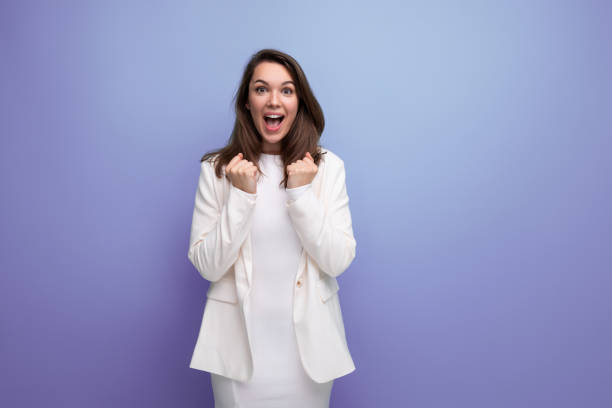istock lucky happy brunette woman in dress on studio background with copyspace 1815496268