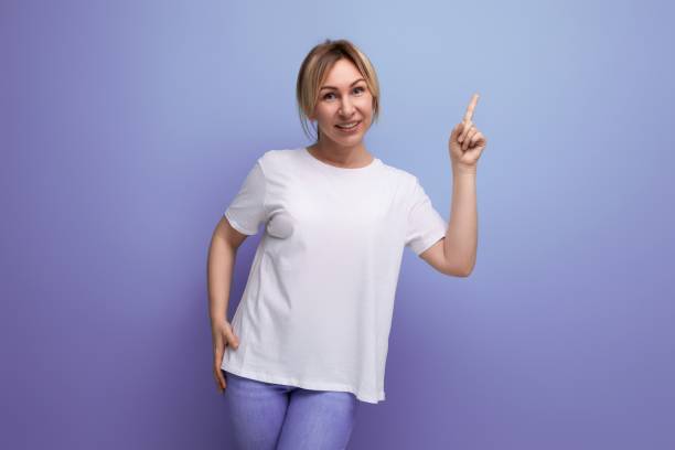 istock blond young woman in a white T-shirt for thermal printing on a studio background with copy space 1815496830