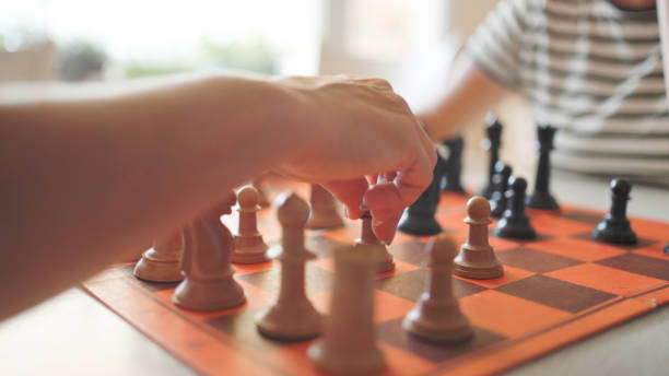 istock Mature woman playing chess with her girlfriend. 1815496870