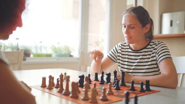 istock Mature woman playing chess with her girlfriend. 1815496876