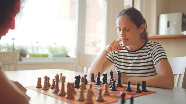 istock Mature woman playing chess with her girlfriend. 1815496925
