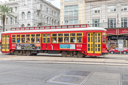 New Orleans, USA - October 24, 2023: red historic street car  at Canal street in New Orleans.