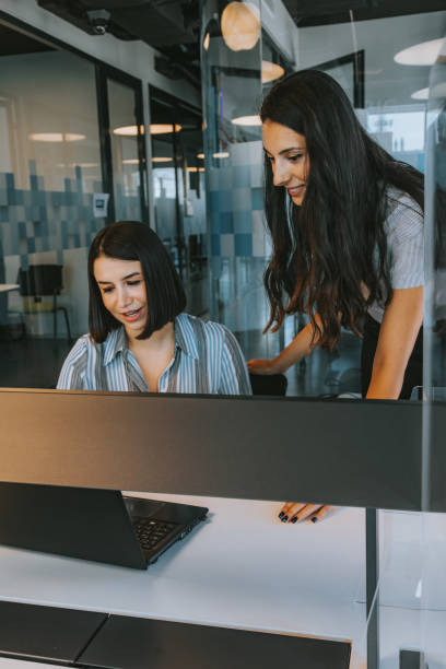 istock Dynamic Duo: Business Women Collaborating in Modern Office Setting 1815508724