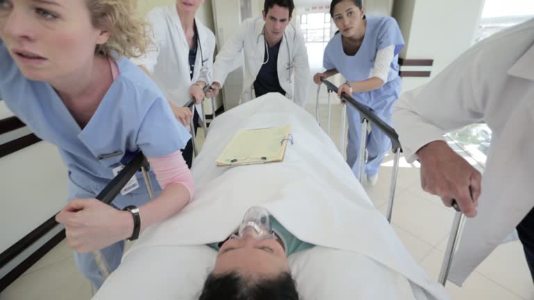 Close up of doctors and nurses pushing stretcher