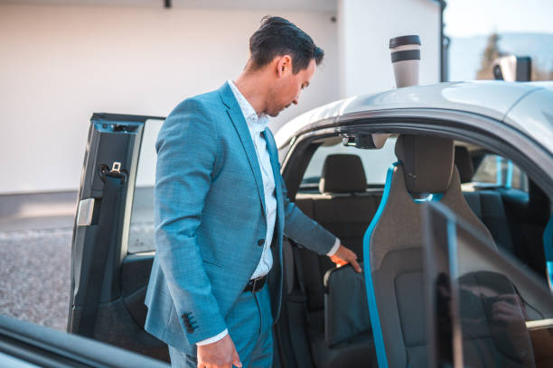istock Mature Man in a Suit Putting Laptop in his Car 1815522977