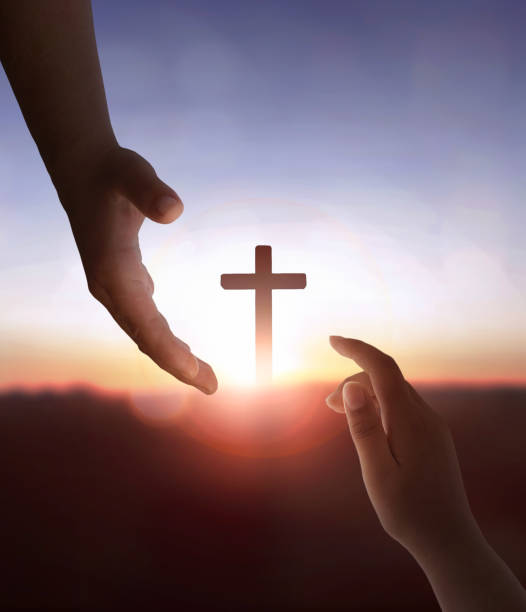 istock Jesus Christ reaching out to help human on cross background 1815522982