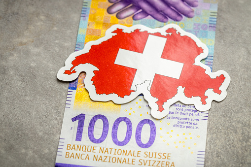 Switzerland money, Swiss banknote, 1000 francs, Highest denomination, national flag and shape of the country of Switzerland, Financial concept business, gray background. copy space