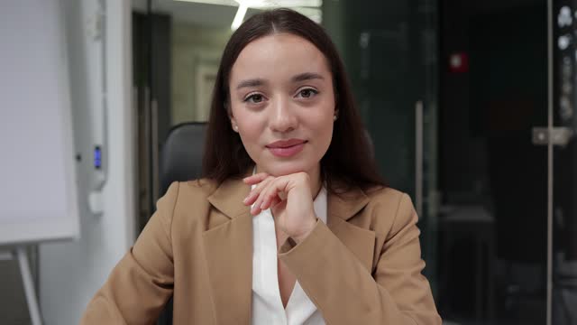 Video conversation business woman look at camera nodding and agree. Portrait of confident young saleswoman listening by videocall head shot portrait.