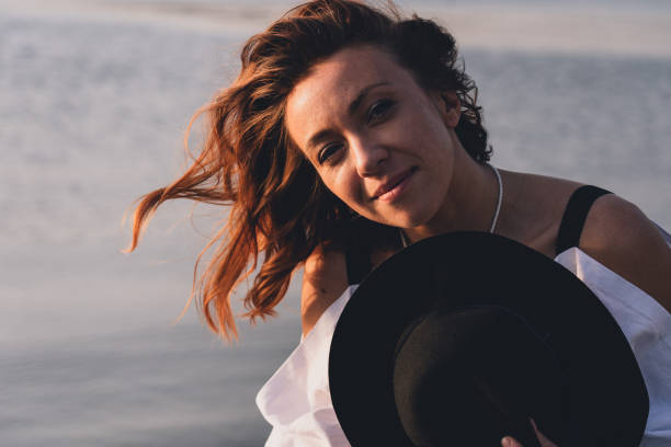 istock Happy bride with black hat in a boat on the river 1815544384