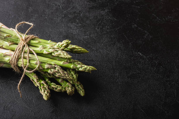 istock Green asparagus on a black background with copy space 1815549939