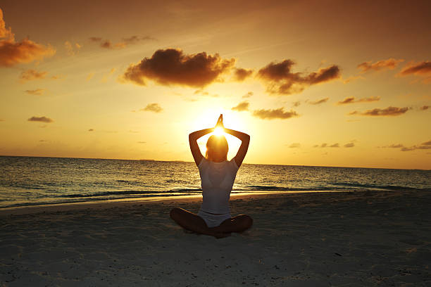 istock sunset yoga woman 181555018