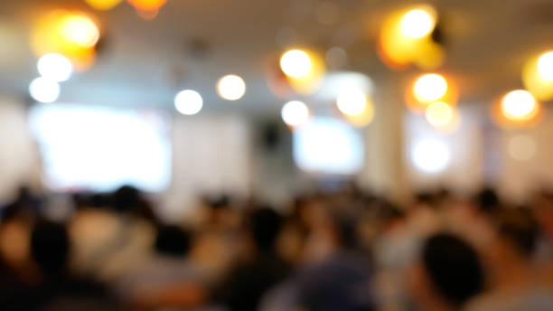 Blurred background Presentation meeting at conference room present screen business. People join seminar business event in auditorium hall convention. Bokeh light Blurred background with copy space