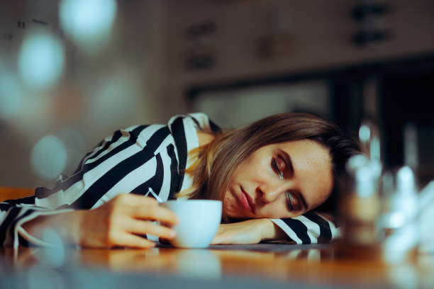 istock Tired Woman Sleeping with the Head on the Table 1815622230